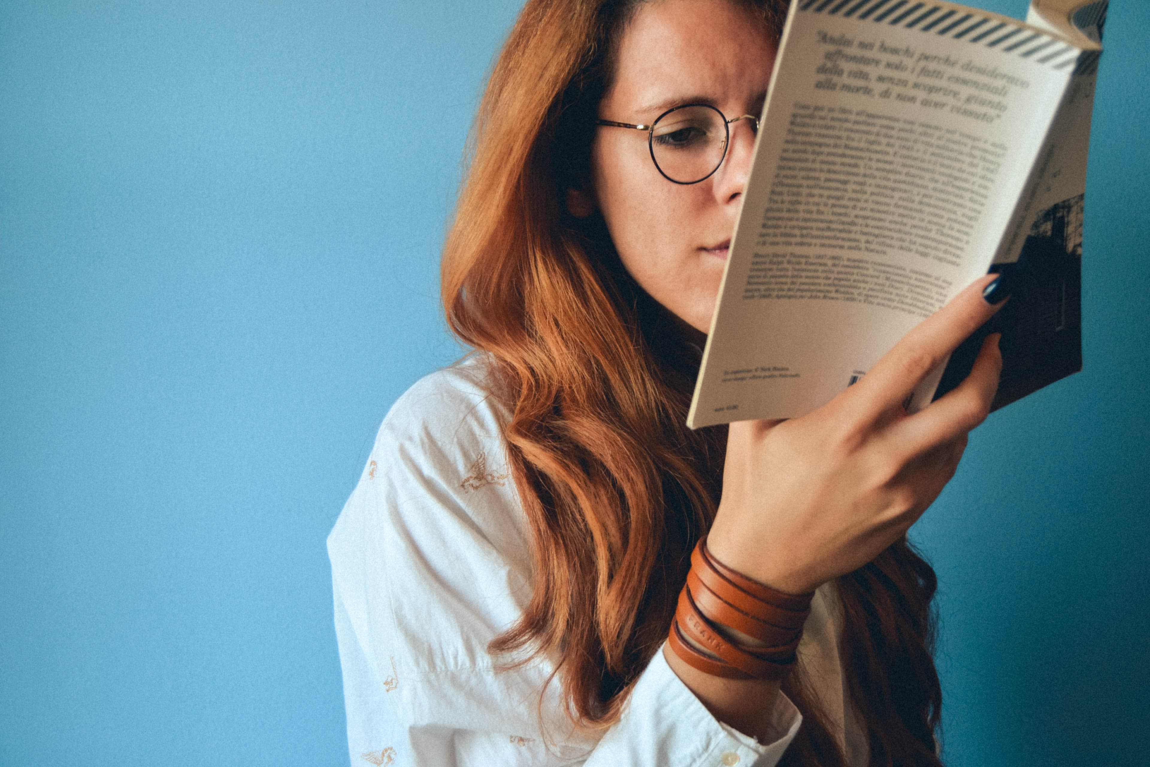 Woman closely examining a book