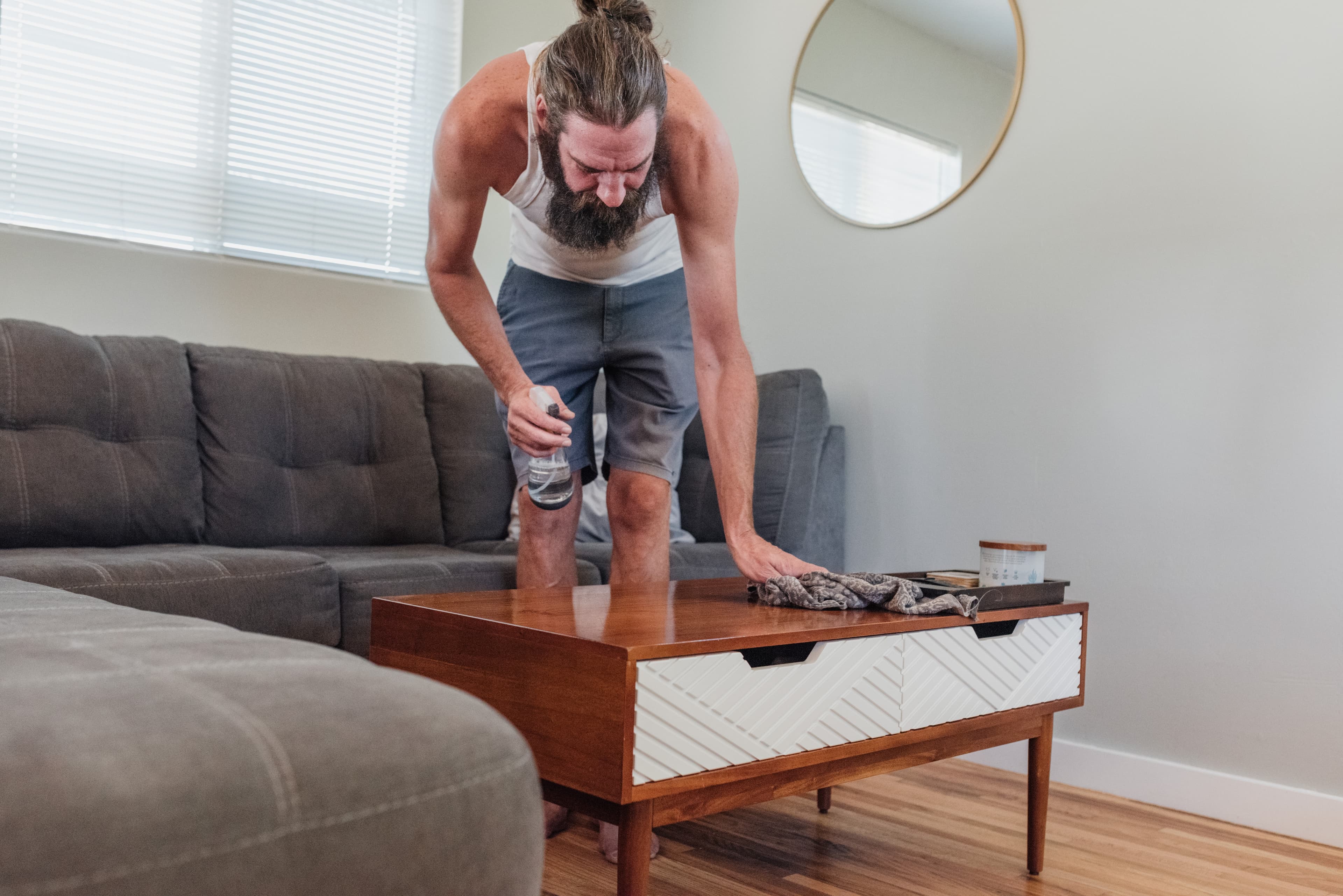 Man dusting table