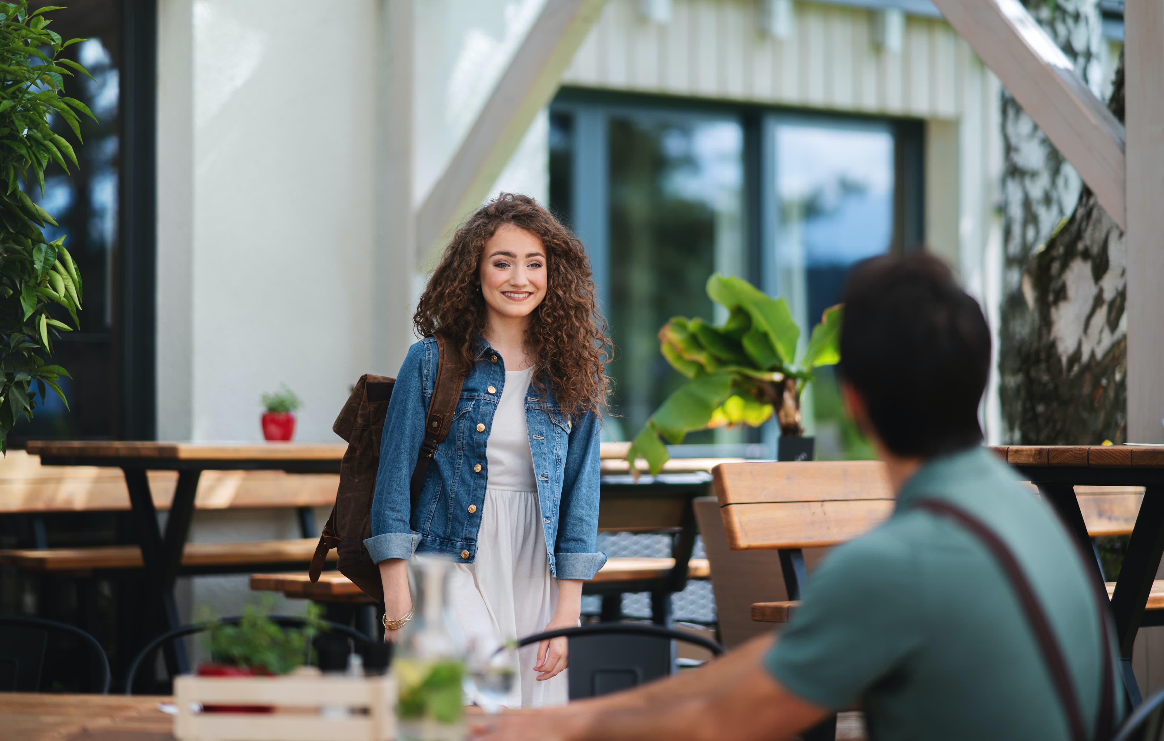 Woman meeting up with a man at a restaurant