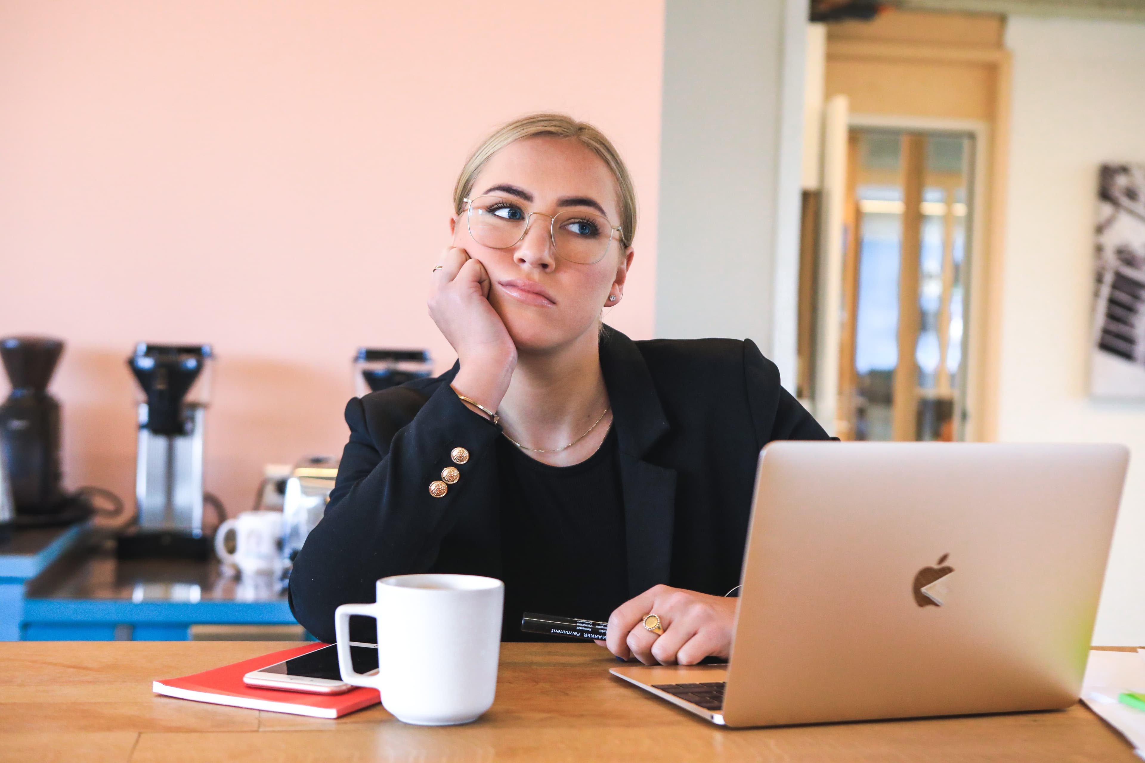 Woman working on laptop thinking