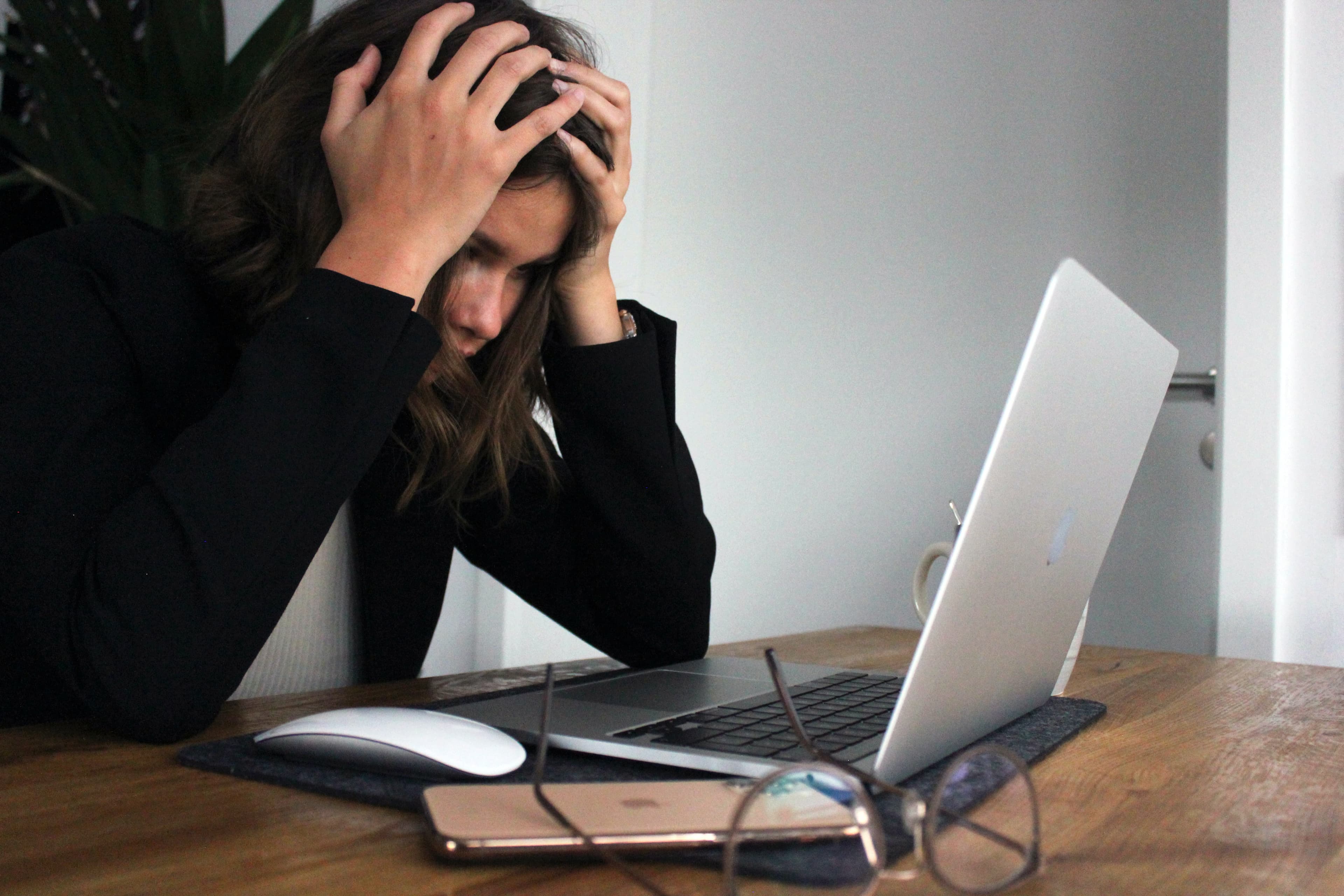 Woman looking frustrated at her laptop